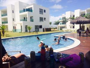 a group of people in a swimming pool at Apartamento Golf Iberostate Praia do Forte in Praia do Forte