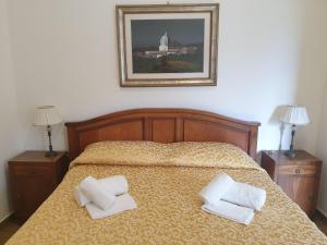 a bedroom with a bed with two pillows on it at Le Rondinelle in San Demetrio neʼ Vestini
