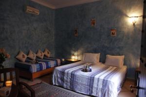 Postel nebo postele na pokoji v ubytování Riad Azenzer