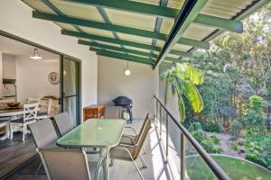 a room with a balcony with a table and chairs at Baden 58 - Rainbow Shores. Aircon. Wifi. Pools Walk to beach in Rainbow Beach