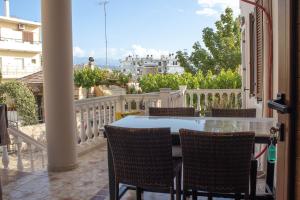 a patio with a table and chairs on a balcony at Mamouth Studios in Chania Town