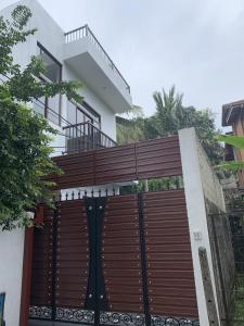 a wooden gate in front of a house at 3 BHK furnished house-apartment in central colombo in Colombo