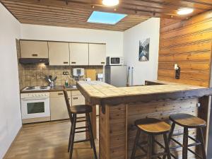a kitchen with a counter and stools in a room at Beautiful Apartments in Zülpich in Zülpich
