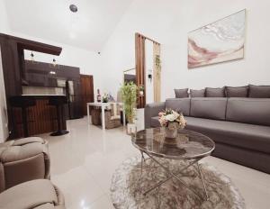 a living room with a couch and a coffee table at Cozy Family Home Rental in General Santos City in General Santos