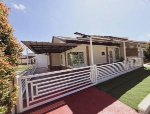 a white fence in front of a house at Cozy Family Home Rental in General Santos City in General Santos