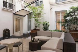 a living room with a couch and a table at Magda Champs Elysées in Paris