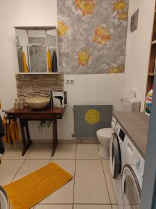 a bathroom with a sink and a toilet at Ferienwohnung Waldblick mit Balkon nahe Therme Loipersdorf in Windisch Minihof