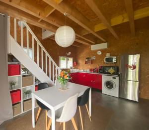 a kitchen with a white table and chairs at La maison du poulailler in Jargeau