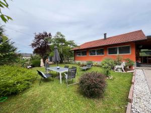 a house with a table and chairs in the yard at Wolf country haus in Sesvete