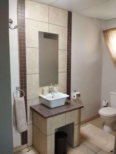 a bathroom with a sink and a toilet at Hopetown Accommodation in Hopetown +7 photos