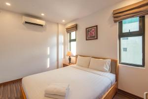 a bedroom with a white bed and a window at 22housing Residence Suites 20 linh Lang in Hanoi
