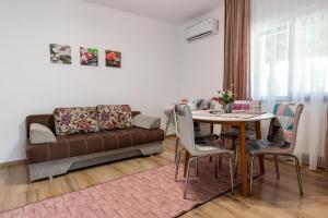 a living room with a couch and a table at Salt Orchid Apartments in Turda