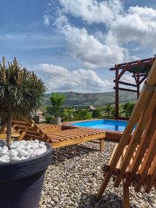 a backyard with a swimming pool and a wooden pergola at Rustic dream MIA in Zlatibor
