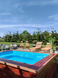 a swimming pool with a deck and lounge chairs around it at Rustic dream MIA in Zlatibor