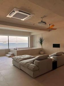 a large living room with a couch and a bed at Paradise on earth in Busan