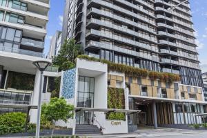 an apartment building with plants on the facade at Cityscape 2-Bed with Pool, Gym & Secure Parking in Brisbane