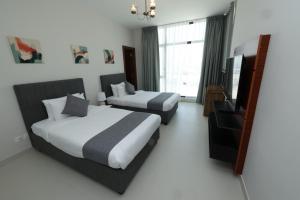 เตียงในห้องที่ Noor Amwaj Hotel & Apartment