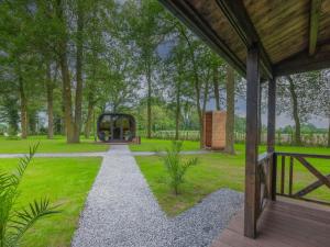 a garden with a playground in a park at Maison Idyllique in Bree
