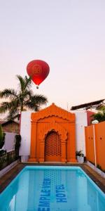 a hot air balloon flying over a swimming pool at Myanmar Nan Hteik Temple View Hotel in Bagan