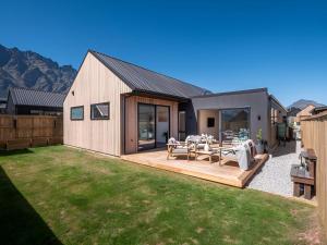 a backyard with a wooden deck and a house at Remarkable stay in Queenstown in Frankton Wharf