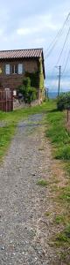 a dirt road next to a house on a hill at La limandière in Morancé