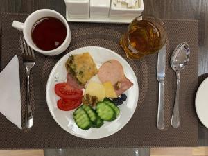 un plato de comida con carne y verduras en una mesa en Alliance Hotel Tashkent, en Tashkent