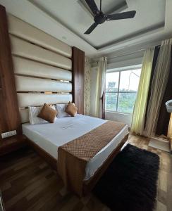 een slaapkamer met een groot bed en een raam bij Jungle Fowl Resort in Dehradun