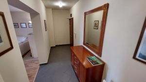 a bathroom with a mirror and a wooden dresser at апартамент Хармония in Gotse Delchev +3 photos