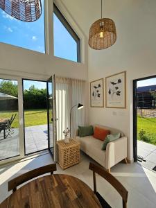 a living room with a couch and a table at Binibona Barn Haven Rydzewo in Rydzewo +17 photos