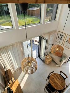 an overhead view of a living room with a table and chairs at Binibona Barn Haven Rydzewo in Rydzewo +17 photos