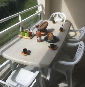 una mesa blanca con comida y bebidas. en L'escale marine, en Pléneuf-Val-André 21 fotos más