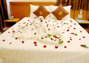 a bed with two swans made out of hearts at Trang Ngan Hotel by THG in Danang