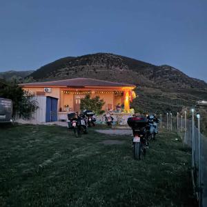 a group of motorcycles parked in front of a house at Pablo's Moto Inn 