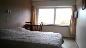 Postel nebo postele na pokoji v ubytování Leo Hotelli