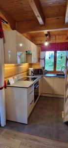 a kitchen with a sink and a stove top oven at Domek Góralski nad Czorsztynem - Kluszkowce in Kluszkowce