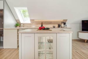 a kitchen with white cabinets and a counter top at Mühlenstraße 13 Whg 2 in Zingst