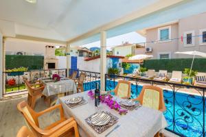 a patio with tables and chairs and a pool at Villa Heyday in Dalyan