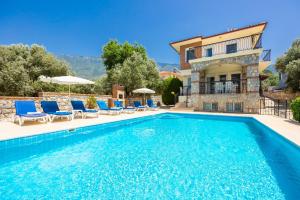 a villa with a swimming pool and a house at Golden Trio Villa in Oludeniz