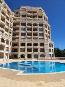 - un grand bâtiment avec une piscine en face dans l'établissement Cabacum Beach Residence апартамент Голубая лагуна, à Varna