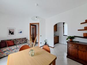 a living room with a table and a couch at Casa Sofi by Quokka 360 - near Rezzonico Castle in Rezzonico