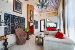 a living room with two couches and a tv at FabHotel Mandiram Palace in Udaipur