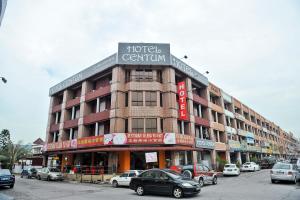 a large building with cars parked in front of it at Hotel Centum in Klang