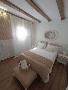 a bedroom with a large bed and a mirror at Casa Laura y Pancho in Fasnia