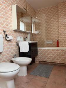 a bathroom with a toilet and a sink and a tub at Apartment Ljubljana - Free parking in Ljubljana
