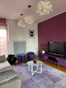 a living room with a couch and a tv and a table at Apartment Ljubljana - Free parking in Ljubljana