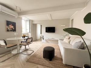 a living room with a white couch and a table at Sweet Menaggio in Menaggio