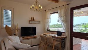 a living room with a couch and a table with a television at Apartmani Stipe in Drage