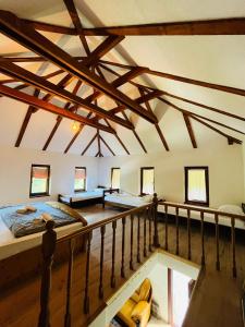 an attic room with two beds and a balcony at Small Bosnian House in Bihać