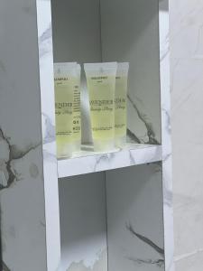 a shelf with three moisturizers on it at Golden Gate Luxury Camp in Wadi Rum