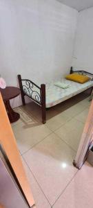 a small bed in a corner of a room at ASHBURN'S TRANSIENT BAGUIO- Dorm rooms 6th floor in Baguio +16 photos
